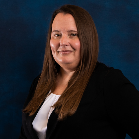 Headshot of Trust Specialist Christina Hankins on blue background.