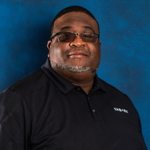 Headshot of Norman Operations Manager Lamar Hammon on blue background.